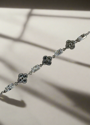 Shiny silver bracelet with flowers and baguette zircons