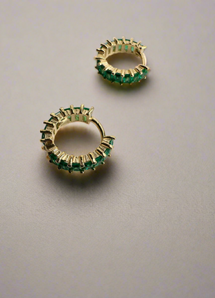 Silver earrings with green baguette zircons.