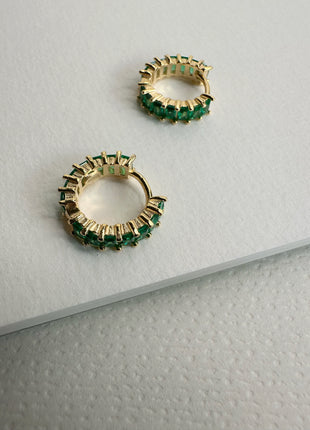 Silver earrings with green baguette zircons.