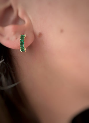 Silver earrings with green baguette zircons.