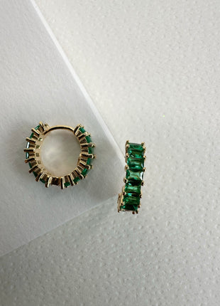 Silver earrings with green baguette zircons.