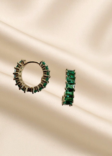 Silver earrings with green baguette zircons.